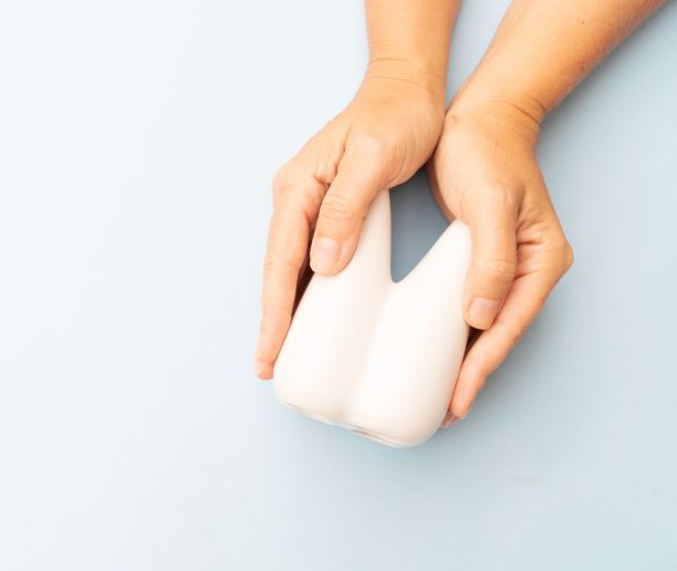 a person holding a giant tooth model